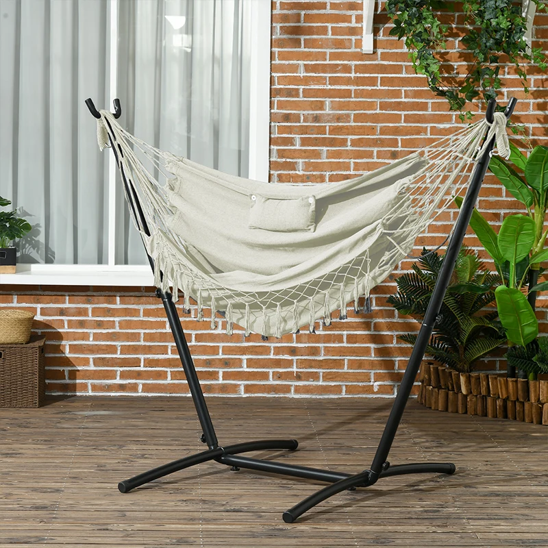 Fabric hammock chair supported by a curved U-shaped metal frame on grass.