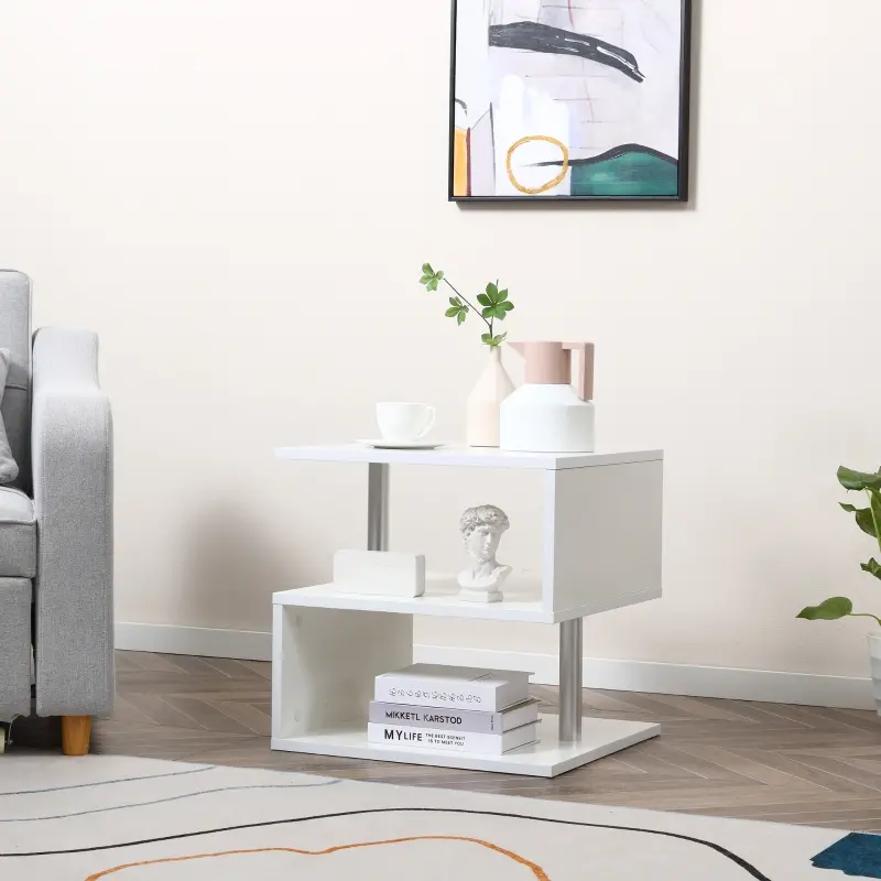 White end table with layered shelving and simple decor placed beside a grey armchair.