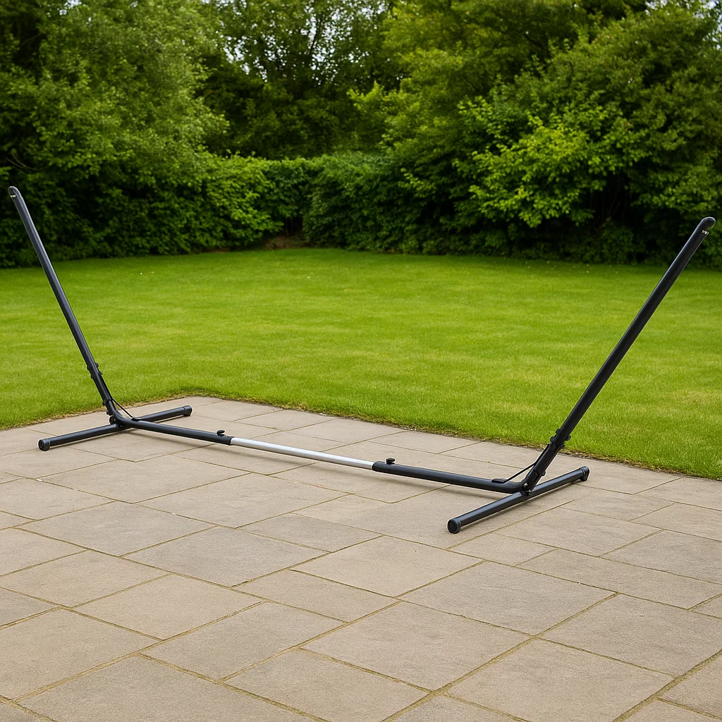 Empty black steel hammock stand in garden highlighting durable frame for outdoor lounging solutions.