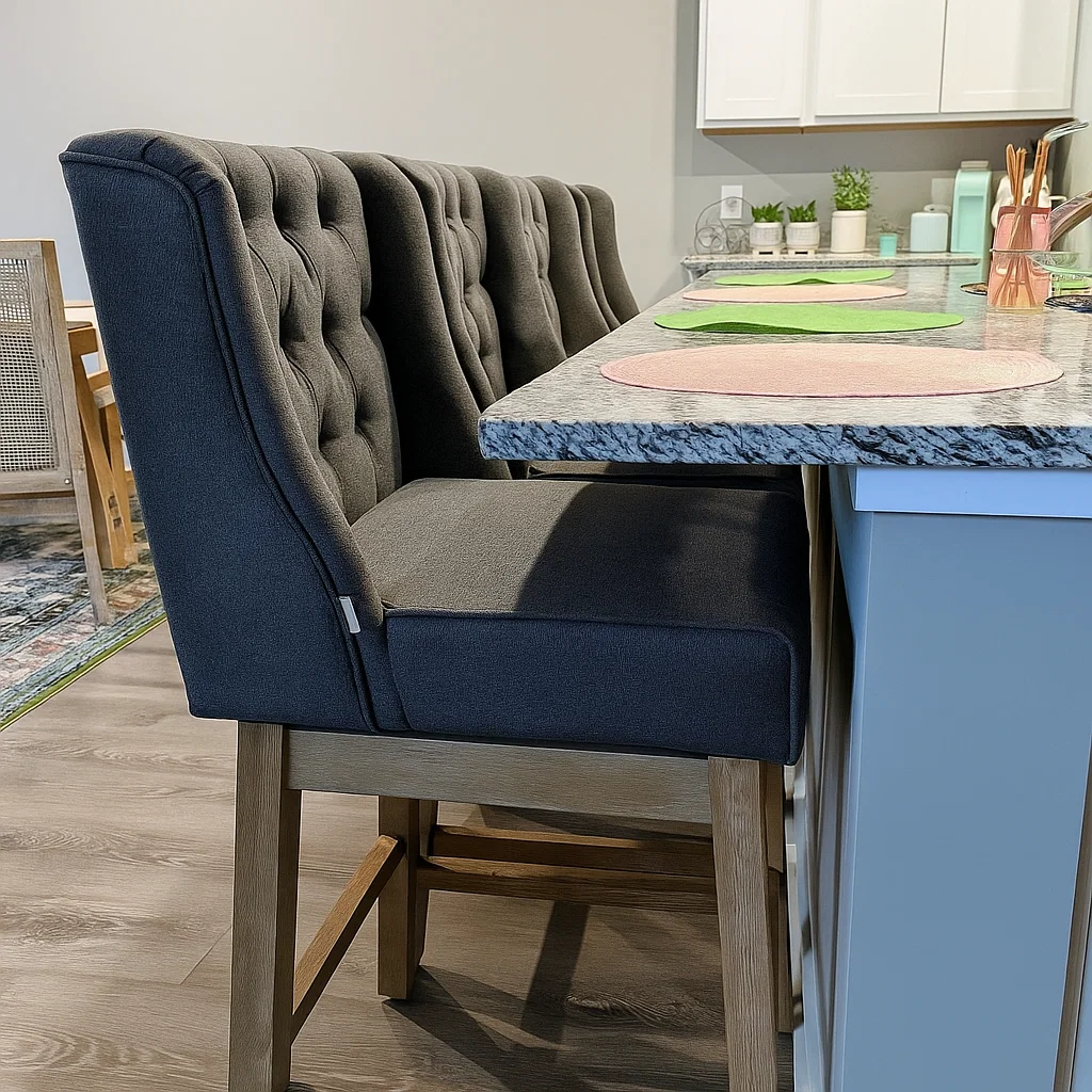 Close-up of tufted black counter stools with granite countertop in a modern kitchen setup.