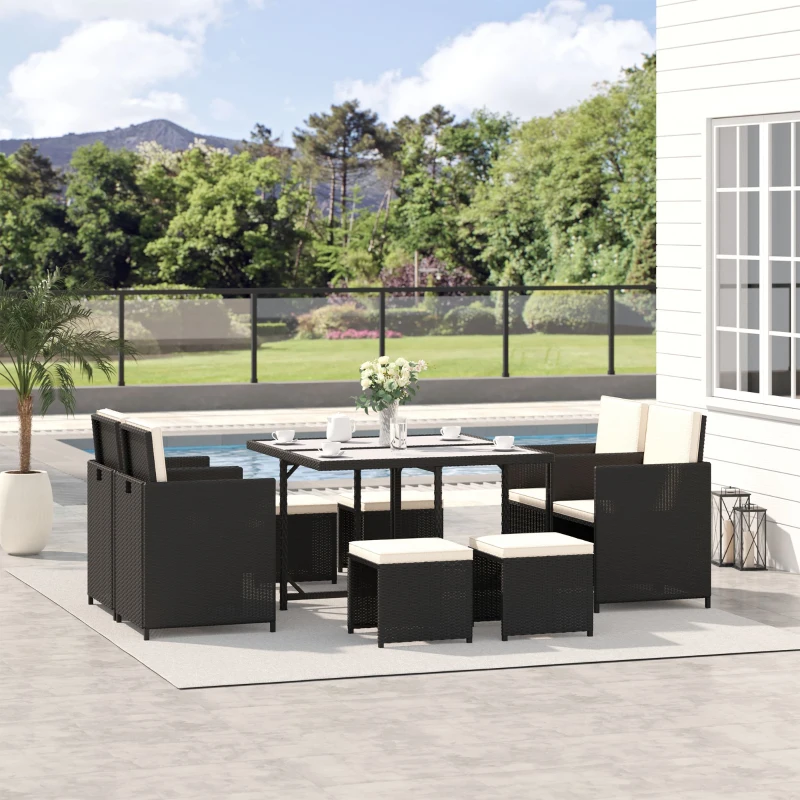 Rattan outdoor dining set with ottomans and chairs.