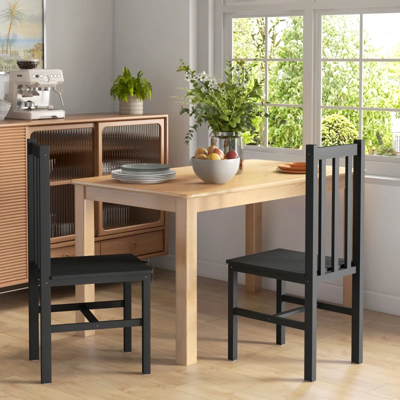 Minimalist black slat-back dining chairs with a natural wood table in a cozy and compact