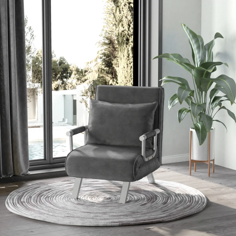 Charcoal grey single futon chair with metal armrests placed on circular rug by large window and plant.
