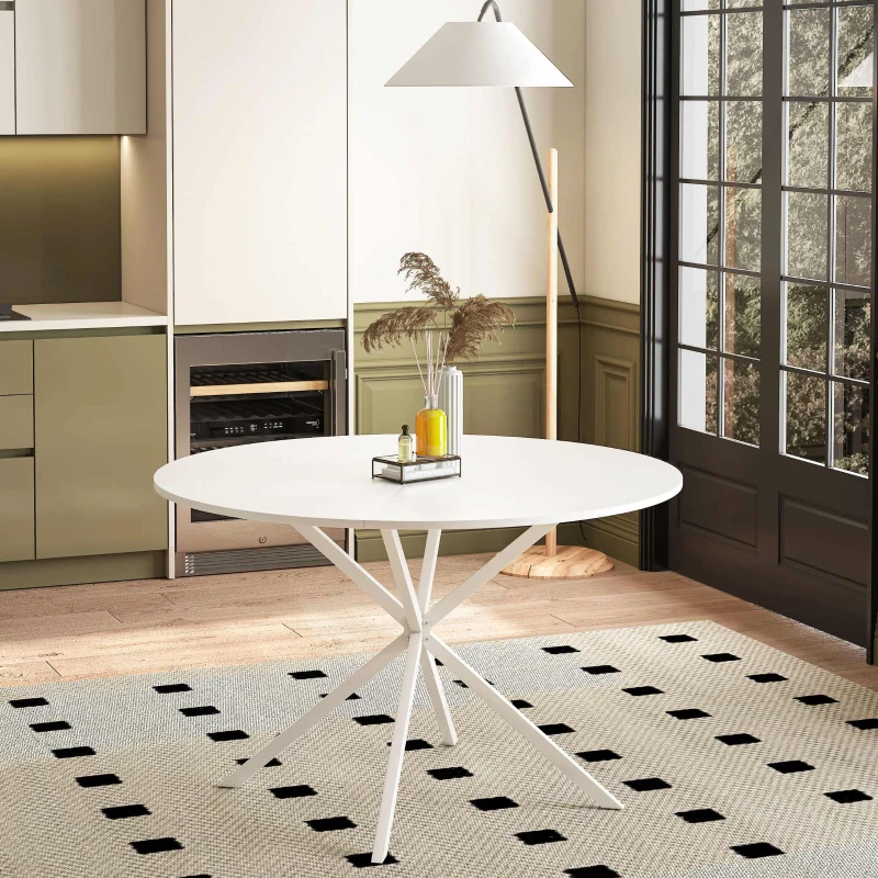 White round dining table with cross metal base in modern kitchen.