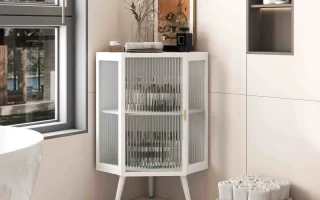 Stylish bathroom corner cabinet with glass doors and decor.