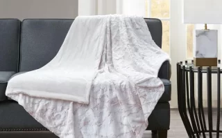 Textured white throw blanket on dark sofa