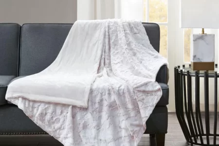 Textured white throw blanket on dark sofa