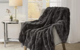 Plush gray throw blanket draped over a chair.