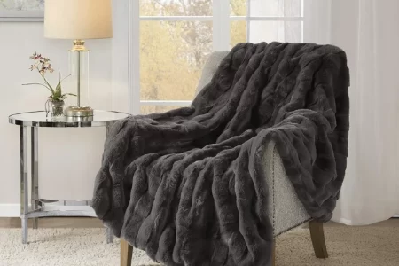 Plush gray throw blanket draped over a chair.
