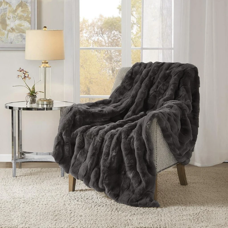 Plush gray throw blanket draped over a chair.