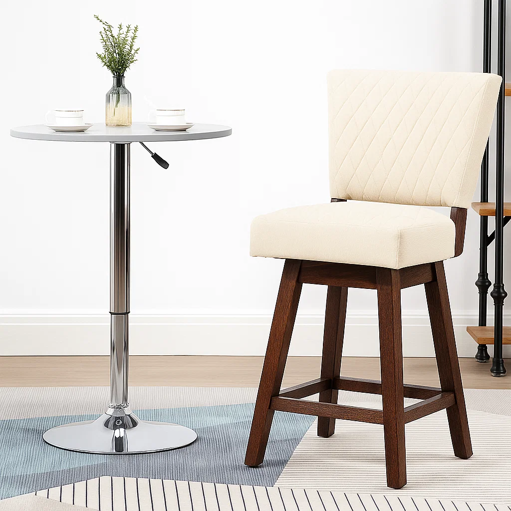 Cream cushioned bar stool beside round silver pedestal table.