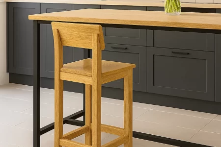 Finished natural wood bar stool beside a kitchen island.