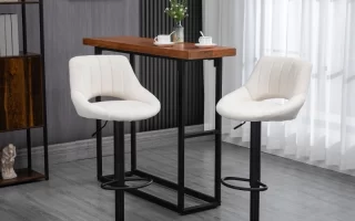 Modern white bar stools near wooden table indoors