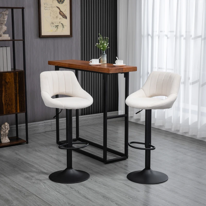 Modern white bar stools near wooden table indoors