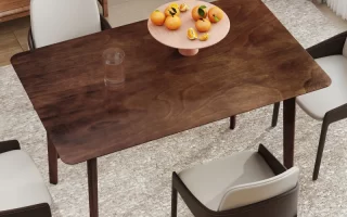 Clean and polished wood dining table with fruit centerpiece in a cozy dining room.