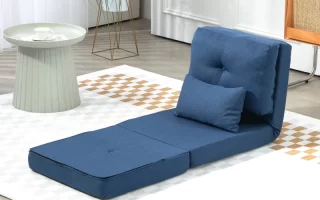 Clean blue futon chair on rug beside round table