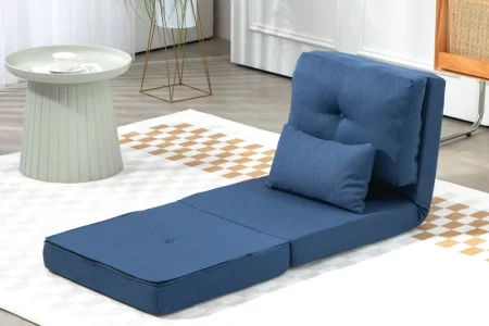 Clean blue futon chair on rug beside round table