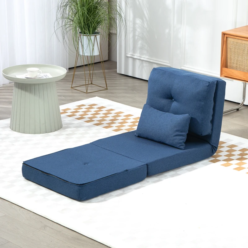 Clean blue futon chair on rug beside round table

