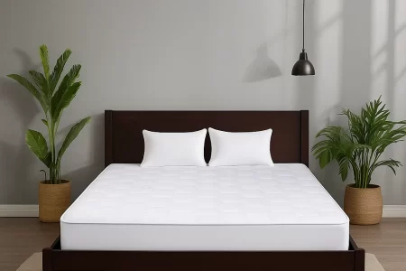 Clean mattress on a dark wood bed with white bedding