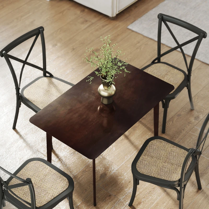 Overhead view of dining table with four chairs and green plant vase.
