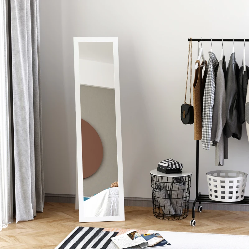 Minimalist full-length mirror in modern bedroom beside clothes rack.
