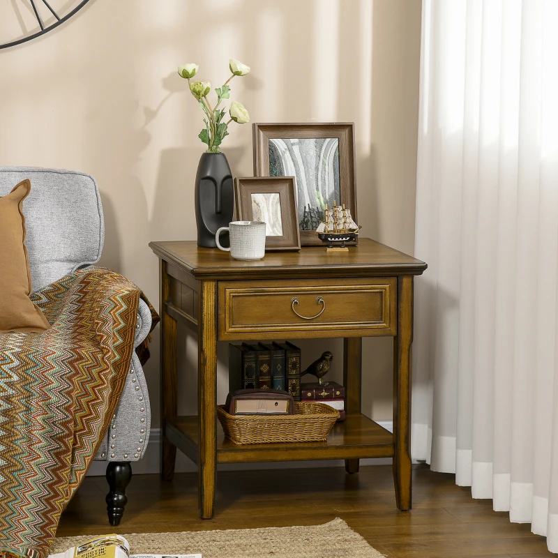 Wooden end table styled with decor, books, and framed photos.