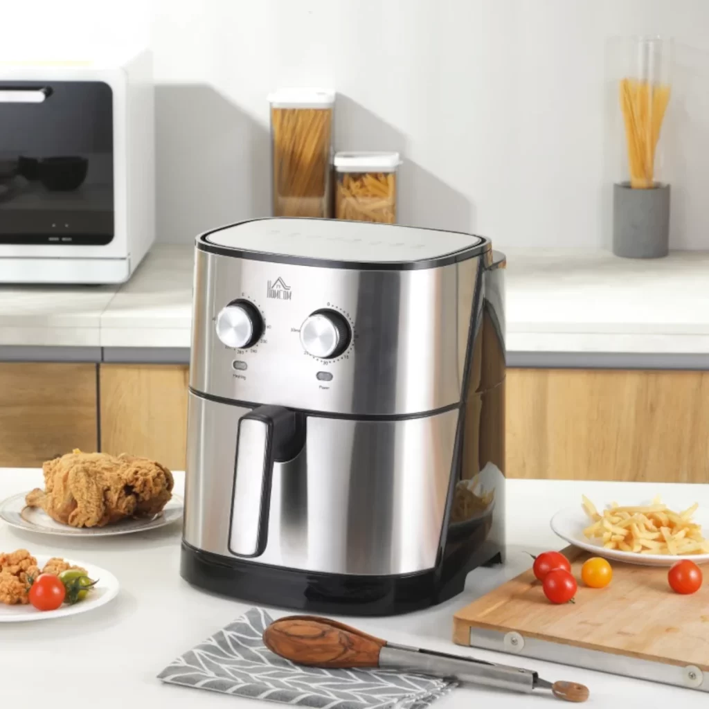 Large capacity stainless steel air fryer with fries and chicken.