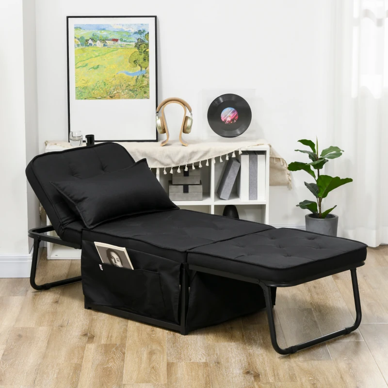 Black padded futon lounger with pillow and storage pockets beside bookcase and framed artwork.
