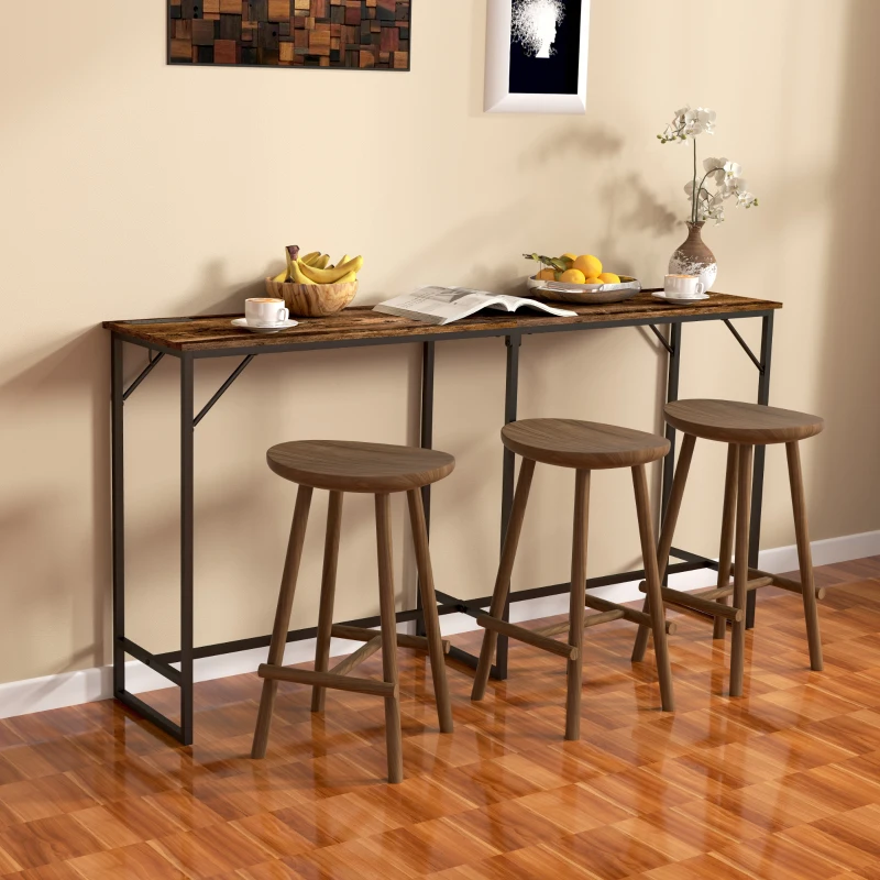 Long wooden bar table with three round stools against beige wall.