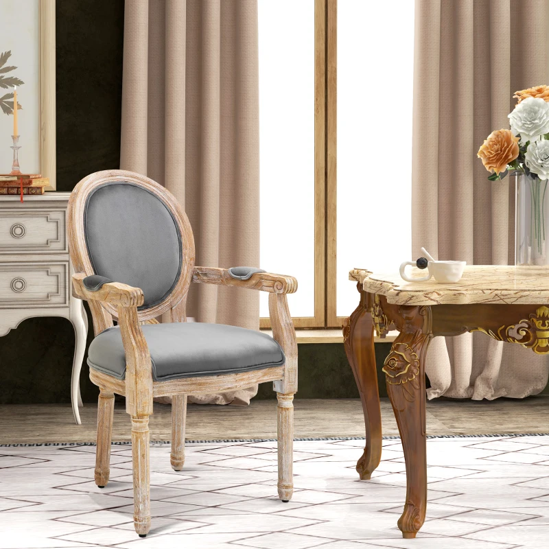 Elegant vintage-style armchair with distressed wood frame and grey upholstery in a traditional dining setting.