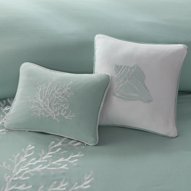 Aqua decorative pillows with coral and shell embroidery
