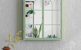 Green framed mirrored wall cabinet reflecting plants and shelves