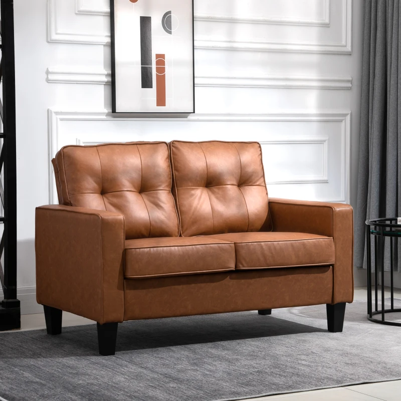 Brown leather loveseat with tufted cushions in bright room
