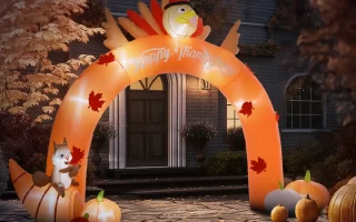 Inflatable turkey arch with pumpkins and squirrel in autumn yard.