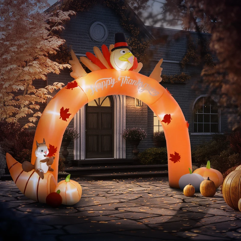 Inflatable turkey arch with pumpkins and squirrel in autumn yard.