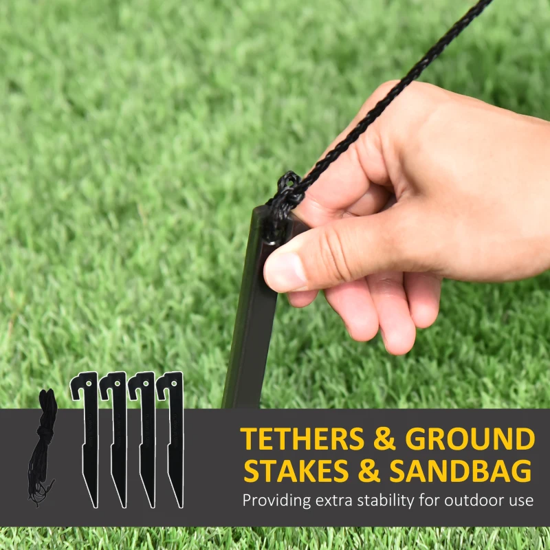 Hand securing outdoor inflatable with ground stake and tether for extra stability on grass.