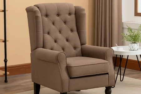 Brown accent chair with wooden legs beside round table.