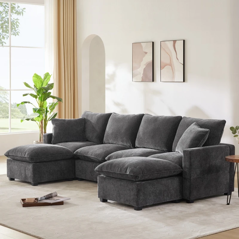 Dark grey sectional sofa with plush cushions in bright living room.
