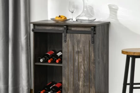 Gray wine cabinet with sliding barn doors and glass decanter.