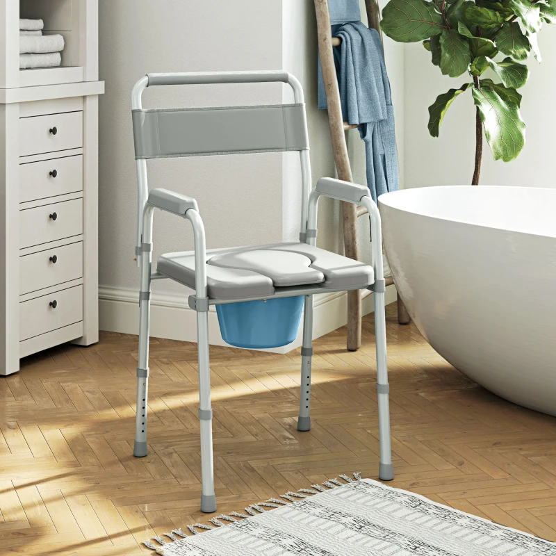 Gray commode chair with padded seat, armrests, backrest, and removable blue bucket.