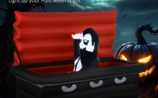 Inflatable vampire rising from red coffin with glowing Halloween pumpkin and full moon background.