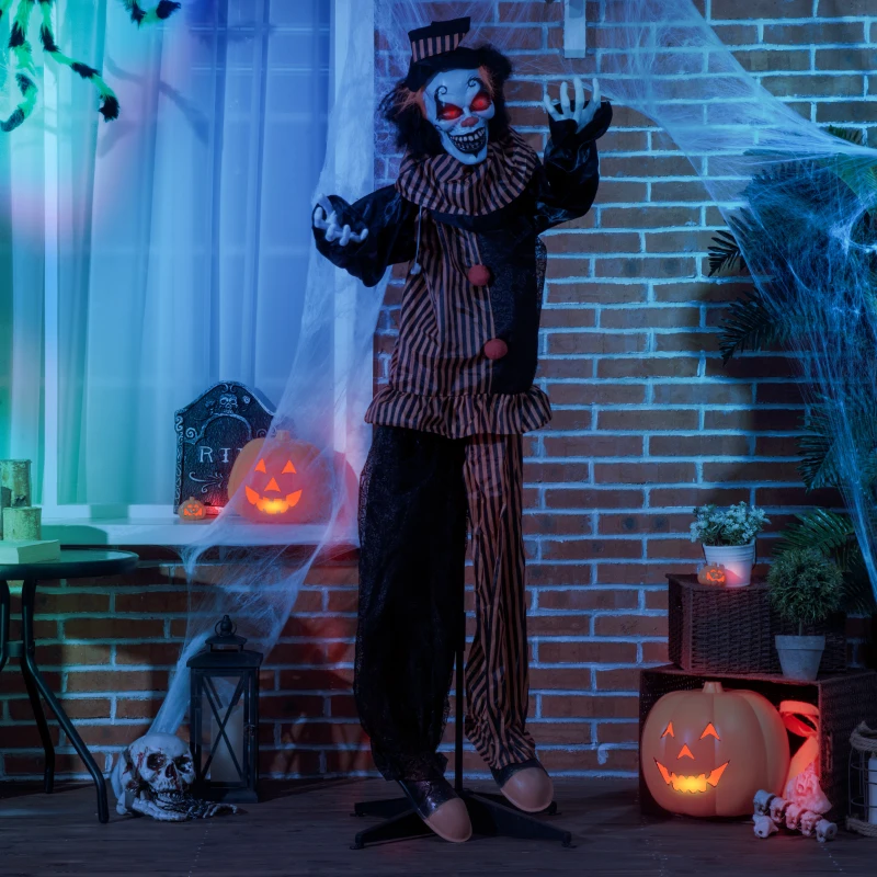 Scary clown prop with glowing eyes and cobweb decorations.