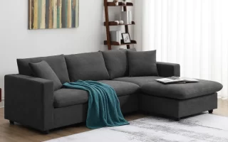 Modern dark grey L-shaped sofa with teal throw blanket.
