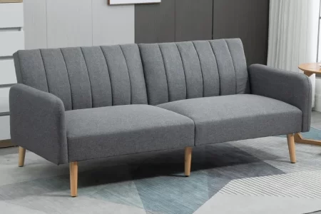 Modern grey fabric sofa with wooden legs in a minimalist living room.