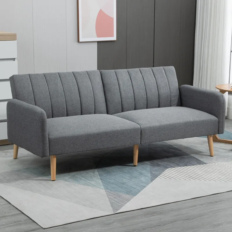 Modern grey fabric sofa with wooden legs in a minimalist living room.