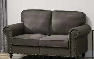 Dark gray fabric loveseat with nailhead trim in living room