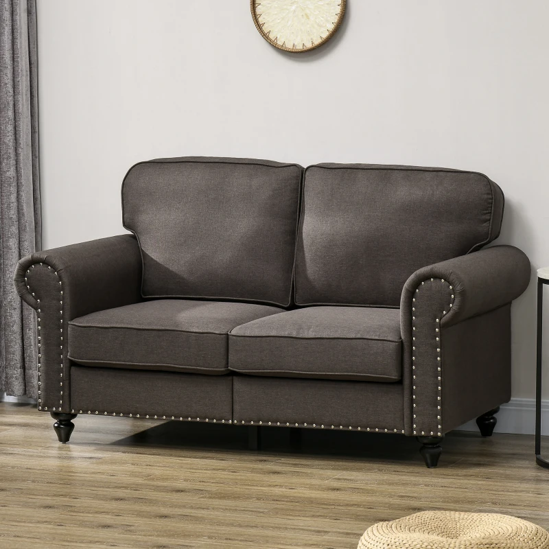 Dark gray fabric loveseat with nailhead trim in living room

