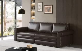 Dark leather sofa with brass stud details in modern living room