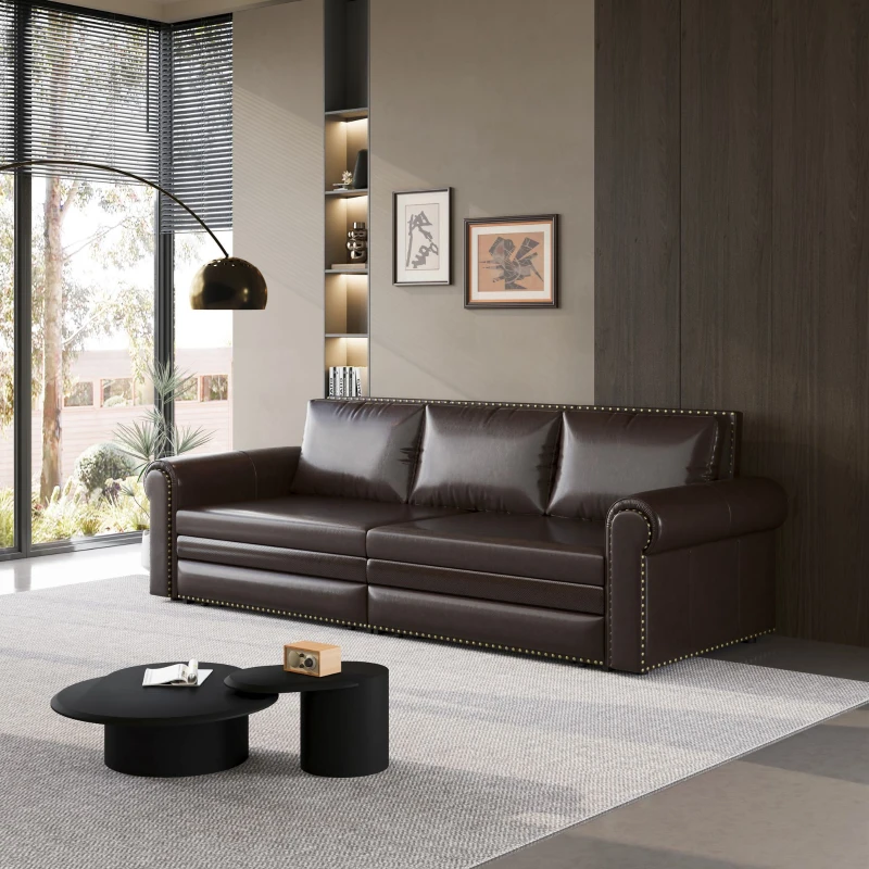 Dark leather sofa with brass stud details in modern living room
