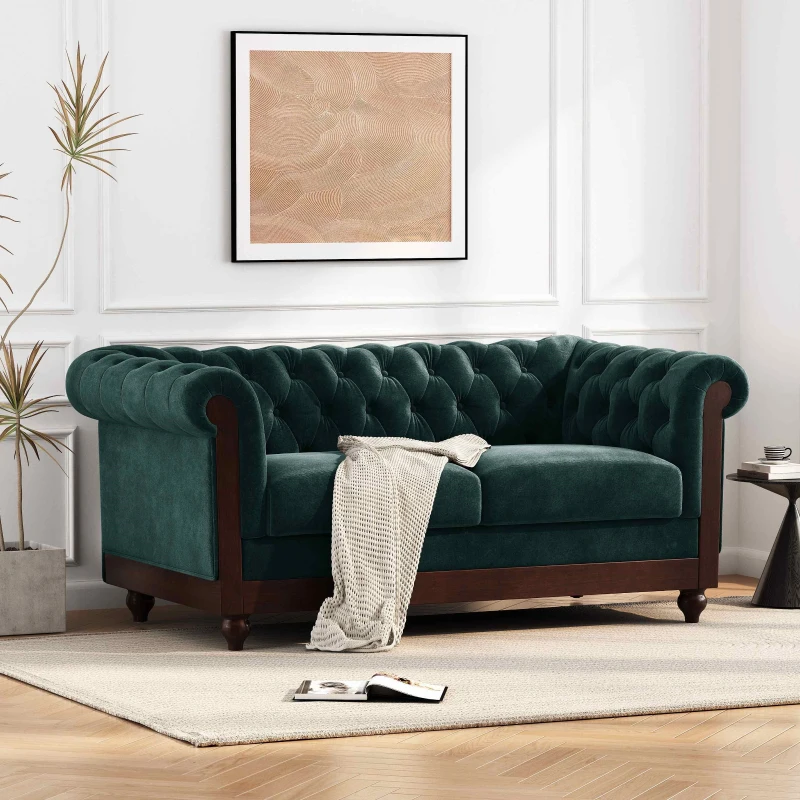 Green velvet sofa in modern living room with wall art.

